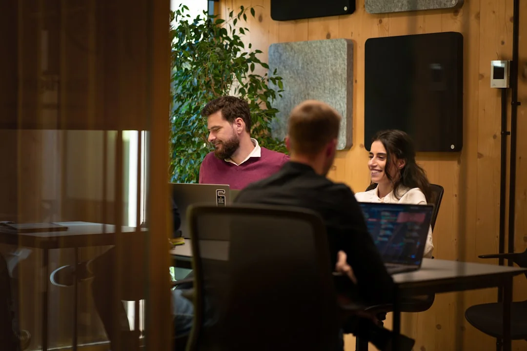 Two business professionals analyzing market trends on digital devices in an office setting.